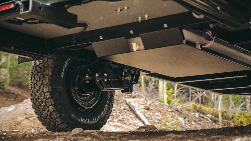 Boreas Campers trailer's bottom and a front wheel pictured from the ground 